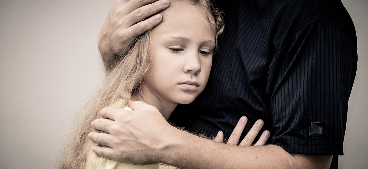 father hugging daughter