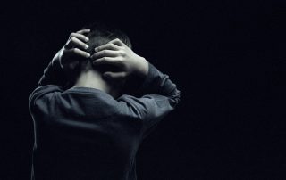 child holding head