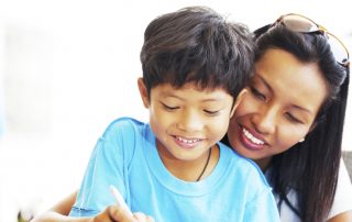 Mom helping her son with homework.