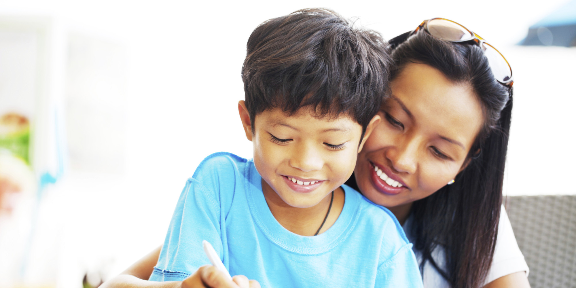 Mom helping her son with homework.